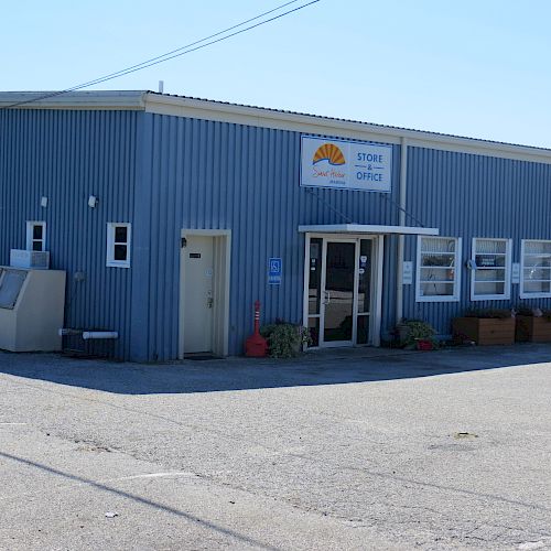 This image shows a blue building with a sign that reads "Store Office" and another sign on the right side.